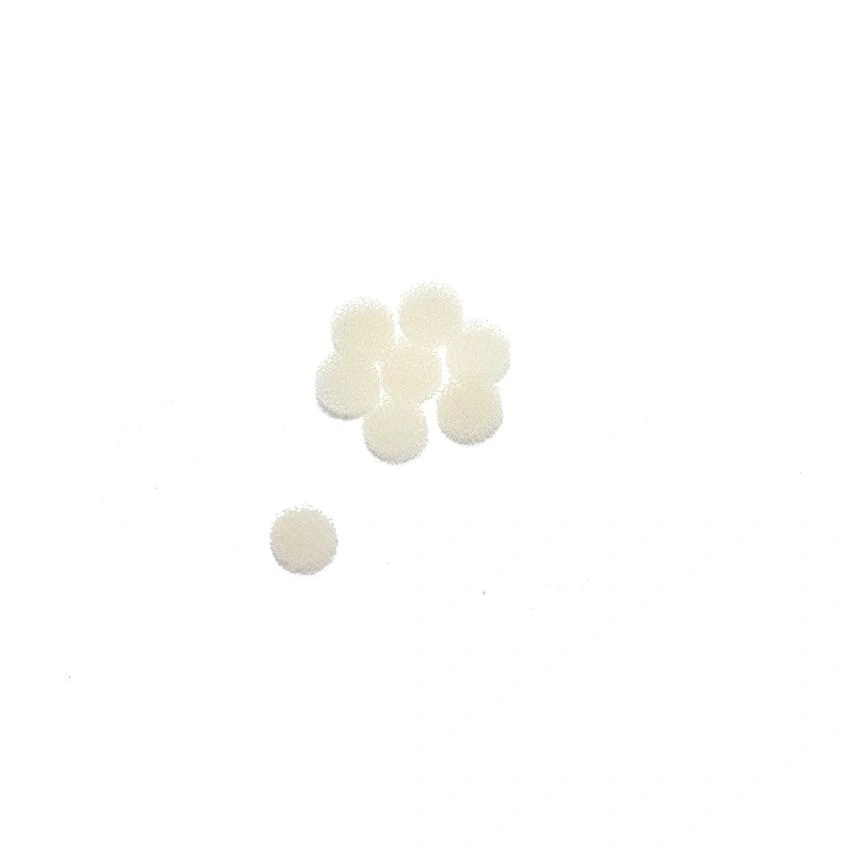 Several small white round foam pads on a white background.